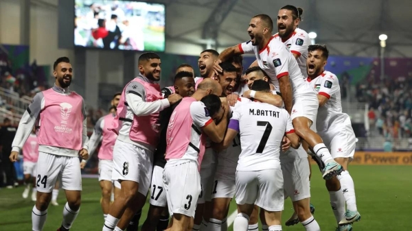 The Palestinian national team celebrates scoring their first goal with teammates in their Group C match against Hong Kong at the Abdullah bin Khalifa Stadium, Doha, Qatar on January 23, 2024