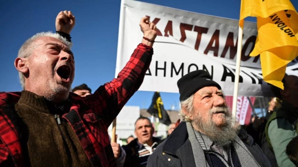 Greek farmers dumped chestnuts and apples on the pavement outside an agricultural fair Sat.rday 