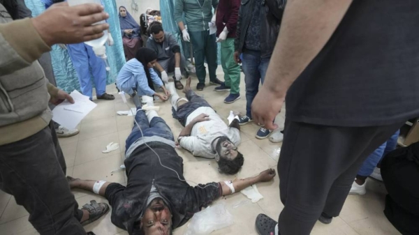 Palestinians wounded in the Israeli bombardment of the Gaza Strip are treated in a hospital in Deir al Balah on Sunday