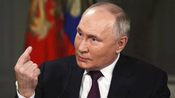 Russian President Vladimir Putin gestures while speaking during an interview with former Fox News host Tucker Carlson