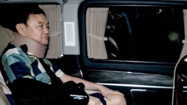 Thailand's former PM Thaksin Shinawatra in a car after his release from a police hospital in Bangkok. — courtesy Getty Images