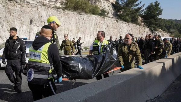 Israeli security forces and members of Zaka rescue service carry a body from the scene of a shooting attack near the West Bank settlement of Maale Adumim, Thursday, Feb. 22