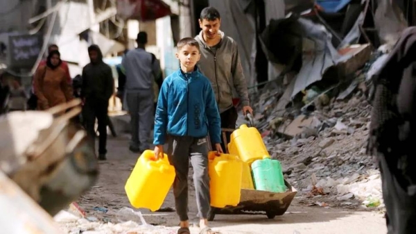 Palestinians carry and fill up the water bottles to meet their water needs from the few underground water sources and mobile tanks as they have limited access to water due to Israeli attacks in Zeitoun neighborhood in Gaza City, Gaza. — courtesy Getty Images