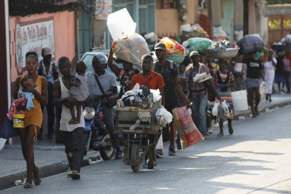 People flee their homes as police confront armed gangs in Port-au-Prince, Haiti, February 29, 2024