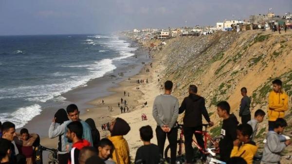 Palestinians wait for aid airdrop at Deir al Balah
