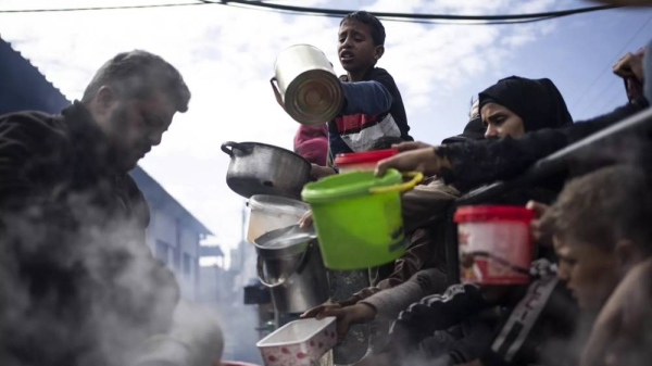 Palestinians line up for a free meal in Rafah, Gaza Strip, Friday, Feb. 16, 2024