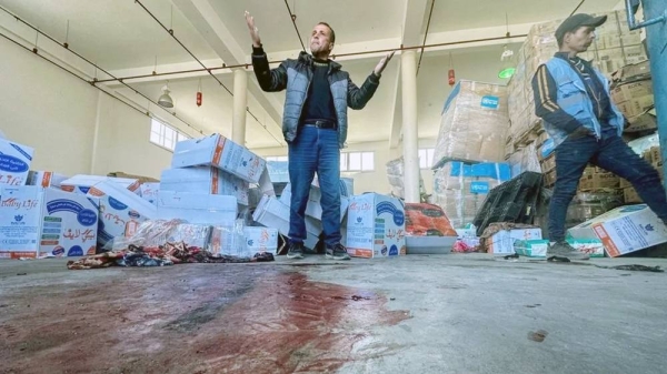 A Palestinian man reacts as blood is seen on the floor at an UNRWA aid distribution center in Rafah, southern Gaza, following an alleged Israeli air strike Wednesday. — courtesy Reuters