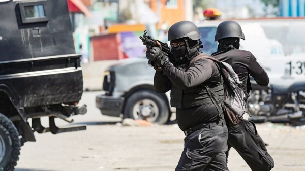 Police officers take part in an operation near the National Penitentiary following a fire in Port-au-Prince, Haiti recently. — courtesy Reuters