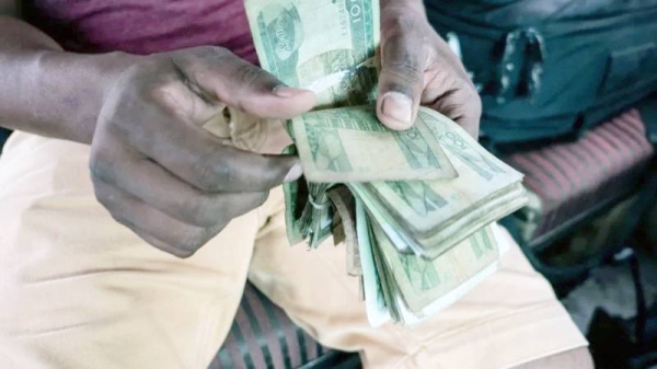 Man counting local Ethiopian currency birr notes. — courtesy Getty Images