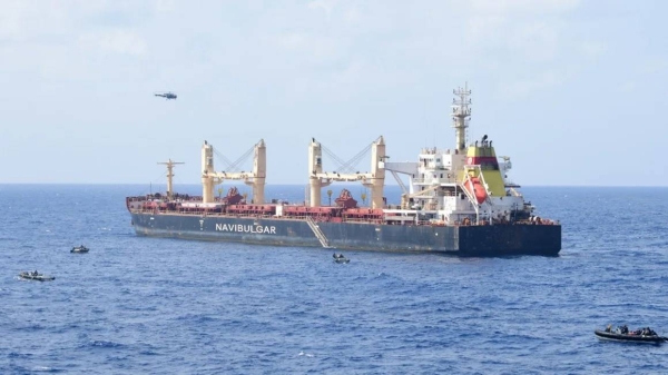 Boats maneuver around the pirated commercial ship MV Ruen during an Indian military operation on Saturday