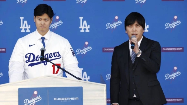 Los Angeles Dodgers player Shohei Ohtani, left, attends an introductory press conference with interpreter Ippei Mizuhara on December 14 at Dodger Stadium in Los Angeles