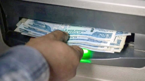 A man withdraws Ethiopian Birr from an ATM in Addis Ababa on Dec. 4, 2023. — courtesy AFP