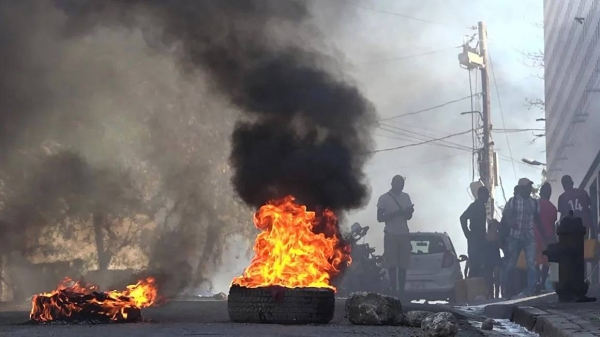 Tires on fire near the main prison of Port-au-Prince, Haiti, on March 3, 2024, after a breakout by several thousand inmates