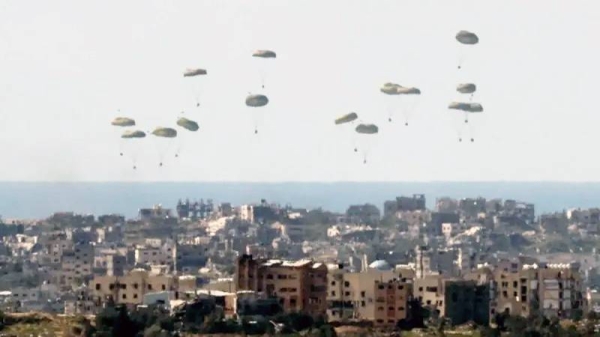 Gazans rush for aid drop in the besieged war-zone.