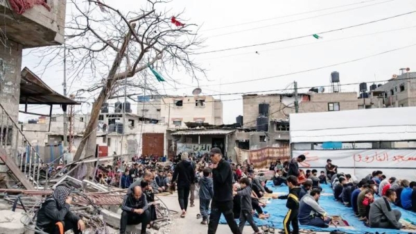 Displaced Palestinians perform the third Friday prayer of the holy month of Ramadan next to the ruins of a mosque destroyed earlier by an Israeli raid in Rafah, southern Gaza Strip. — courtesy EPA