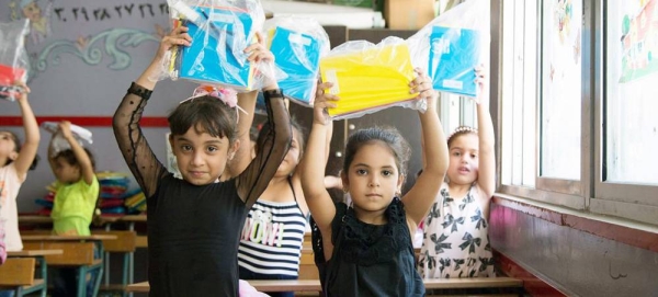 Palestinian children receive stationery items at an UNRWA school in south Lebanon. — courtesy UNICEF/Dalia Khamissy