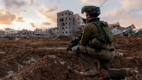 An Israeli soldier takes position in the Gaza Strip, amid the ongoing conflict between Israel and the Palestinian group Hamas