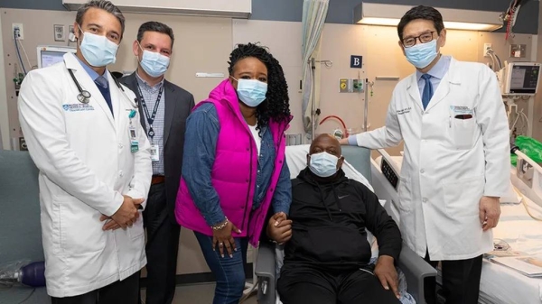 Rick Slayman (seated) pictured with his partner and team of doctors