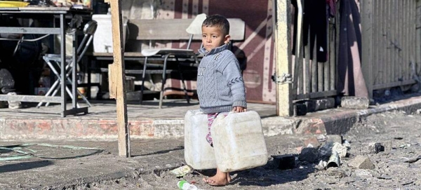 A young boy carries water cans in the Gaza Strip. — courtesy UNRWA