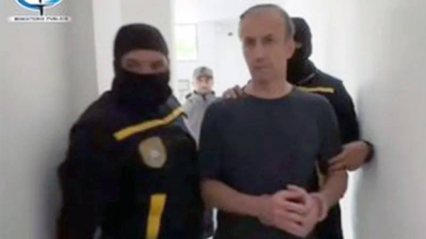 Tareck El Aissami shown being led away in handcuffs in a photo released by the Ministry of Communication. — courtesy Venezuelan Ministry of Communication