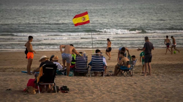 Bathers enjoy the beach in Barbate in southern Spain's Cadiz province