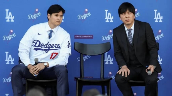 Shohei Ohtani answers questions and Ippei Mizuhara translates during the Los Angeles Dodgers Press Conference