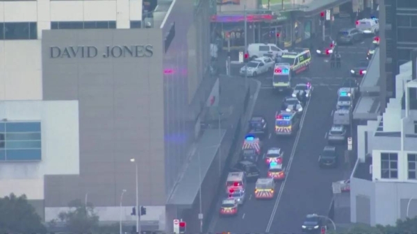 Emergency vehicles can be seen outside the shopping centre as the police operation continues