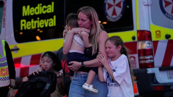 People are led out from the Westfield Shopping Centre where multiple people were stabbed in Sydney, Saturday, April 13, 2024