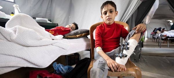 Children receive treatment in a temporary field hospital in Mouraj, a neighborhood in the south of the Gaza Strip. — courtesy WHO/Christopher Black