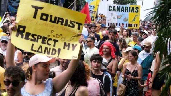 Protesters in Santa Cruz de Tenerife hold placards against mass tourism in Spain's Canary Islands. — courtesy EPA