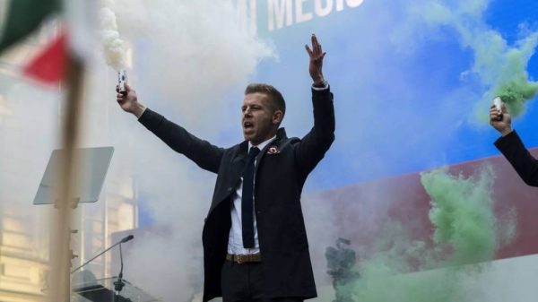 Péter Magyar, former husband of one-time justice minister and Orbán ally Judit Varga holds a smoke-candle after his speech on Hungary's National Day in Budapest on Friday