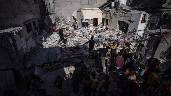 A family inspects their house after it was hit by an Israeli airstrike in Rafah, southern Gaza, April 4, 2024