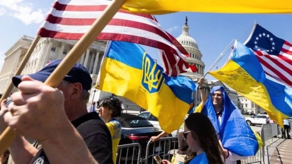 Supporters of Ukraine wave US and Ukrainian flags outside the US Capitol after the House approved foreign aid packages to Ukraine. — courtesy EPA-EFE