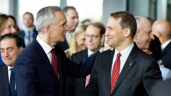 NATO Secretary General Jens Stoltenberg, left, shakes hands with Poland's Foreign Minister Radoslaw Sikorski, April 4, 2024