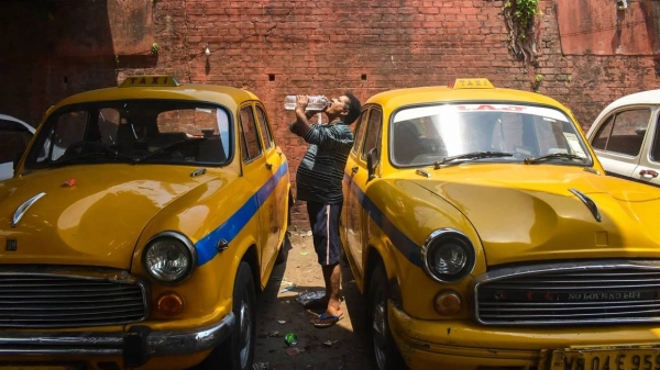 A taxi driver drinks water during a heat wave in Kolkata, India, on April 21, 2024
