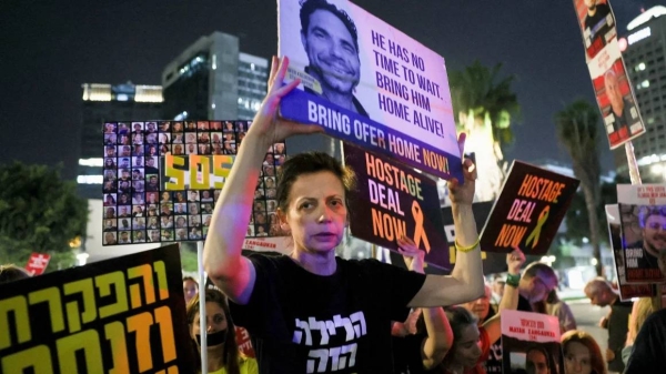 Protesters hold posters calling for the immediate release of Israeli hostages held in Gaza, in Tel Aviv, Israel, on Thursday