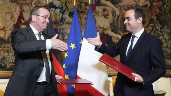 French Defense Minister Sebastien Lecornu, right, and his German counterpart Boris Pistorius shake hands after signing an agreement in Paris on Friday, April 26