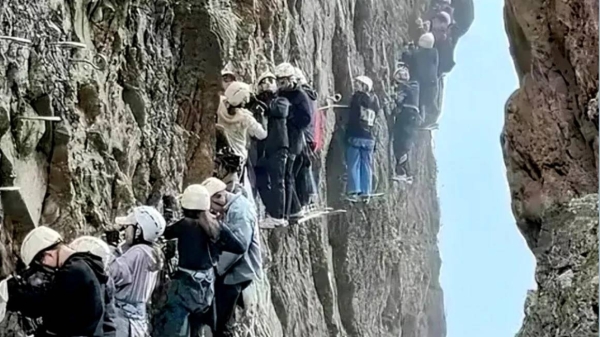 This screengrab shows tourists trapped on a rock climbing trail in eastern China during the Labor Holiday long weekend