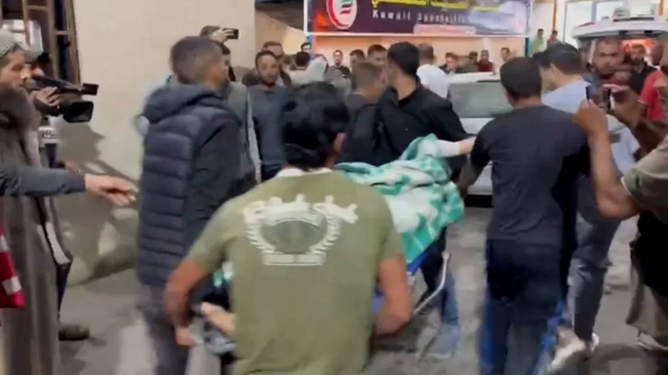 Palestinians arrive at Al Kuwaiti Hospital in Rafah, Gaza, after Israeli air strikes on May 8
