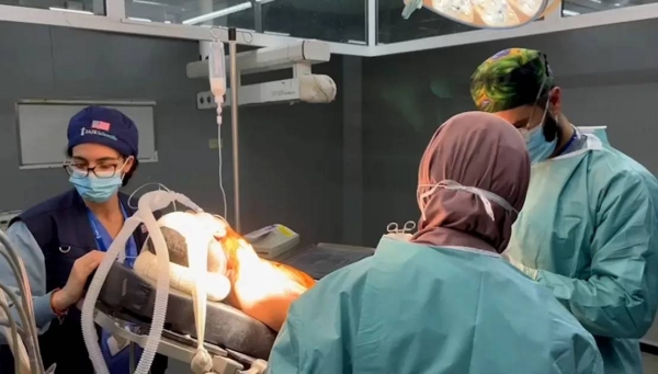 Dr. Ahliah Kattan, left, in an operating room of the European Hospital in northern Rafah