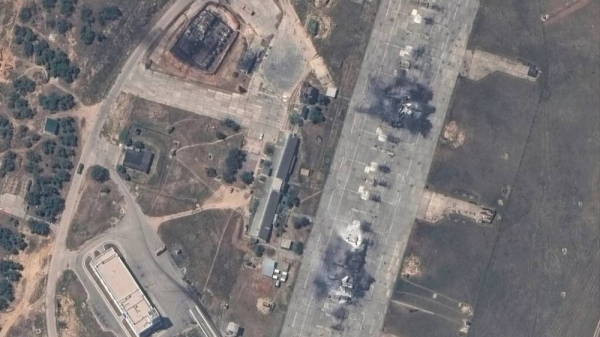 An overview of a destroyed Russian MiG 31 fighter aircraft and fuel storage facility at Belbek air base, near Sevastopol, in Crimea