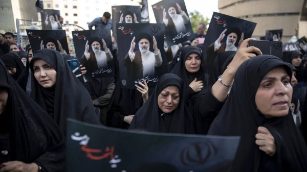 People mourning President Ebrahim Raisi and Foreign Minister Hossein Amir-Abdollahian in Tehran on Monday