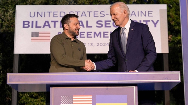 President Joe Biden and Ukrainian President Volodymyr Zelenskyy shake hands after signing a security agreement on the sidelines of the G7, Thursday, June 13,