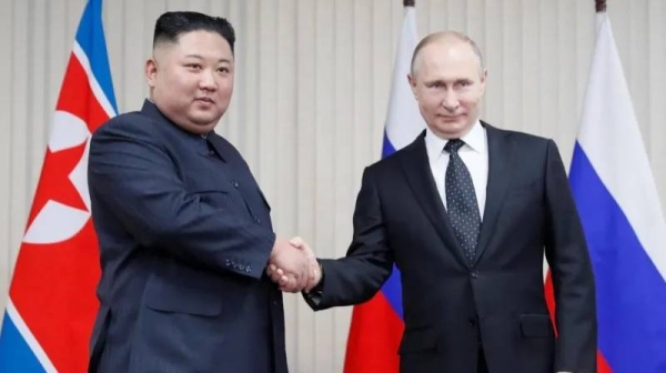 Kim Jong-un and Vladimir Putin shake hands in 2019