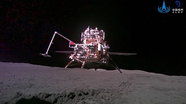 The Chang’e-6 probe is seen raising a Chinese flag with a robotic arm on the moon’s far side earlier in June