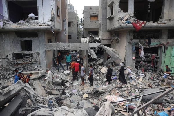 Palestinians inspect the damage a day after Israeli forces launched an operation to rescue four hostages, in Nuseirat, central Gaza, on June 9