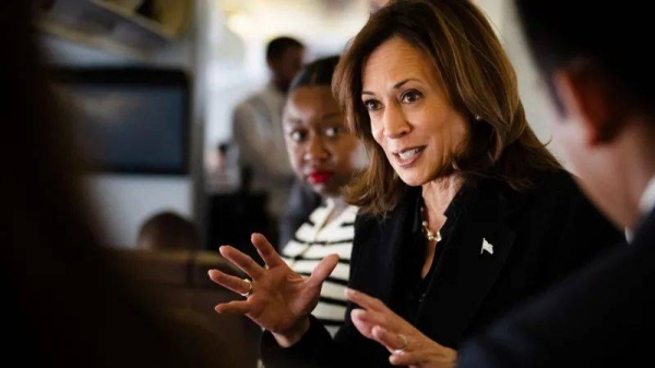 Democratic presidential nominee US Vice President Kamala Harris talks to reporters