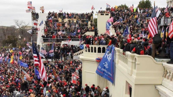 Supporters of then-US President Donald Trump gather are seen covering the front steps of the Capitol building on 6 January