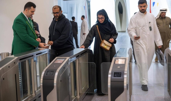 Passengers use their tickets to enter the metro station on Sunday morning.