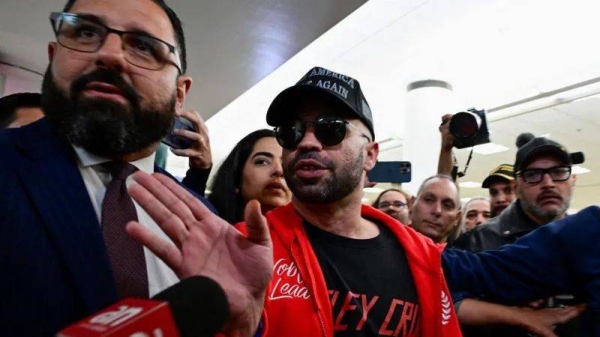 Enrique Tarrio (centre) speaks to reporters in Miami after his release from prison